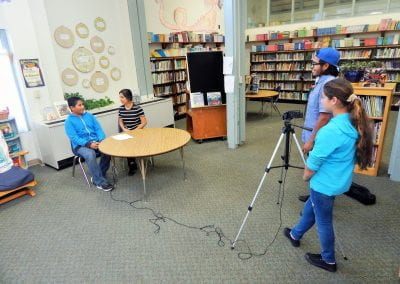 CLV mentors and student videotaping an interviw