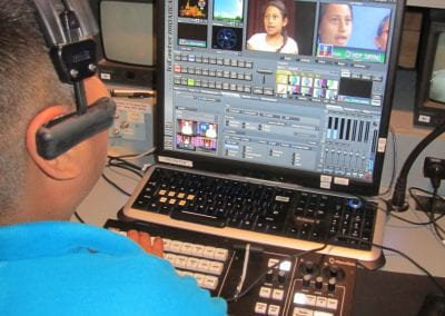 Bayview Elementary student in front of controls at Community TV studio